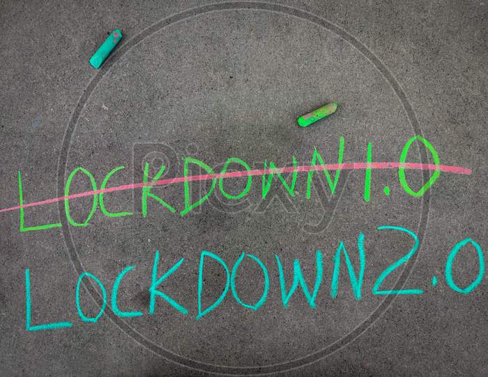 The Inscription Text On The Grey Board, Strike Out Lockdown 1.0 And Lockdown 2.0 Using Color Chalk Pieces.