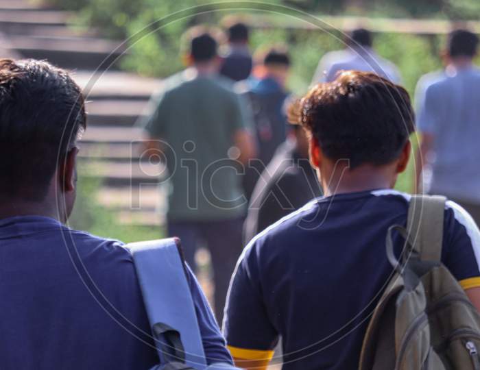 Ider, India - September 27 2020 : Young Asian traveling backpacker on the way of mountain with his friends.
