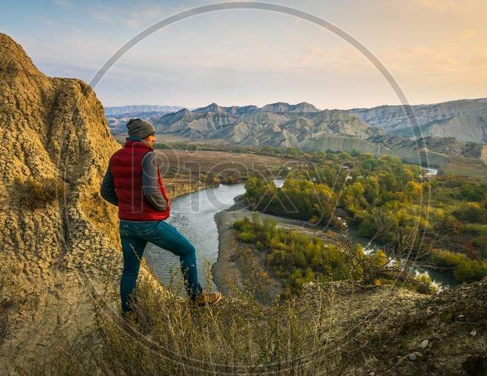 Male Person Stands On The Edge And Look Right To Sunrise With Stunning Landscape View Of Mijniskure. Vashlovani Nature Reserve