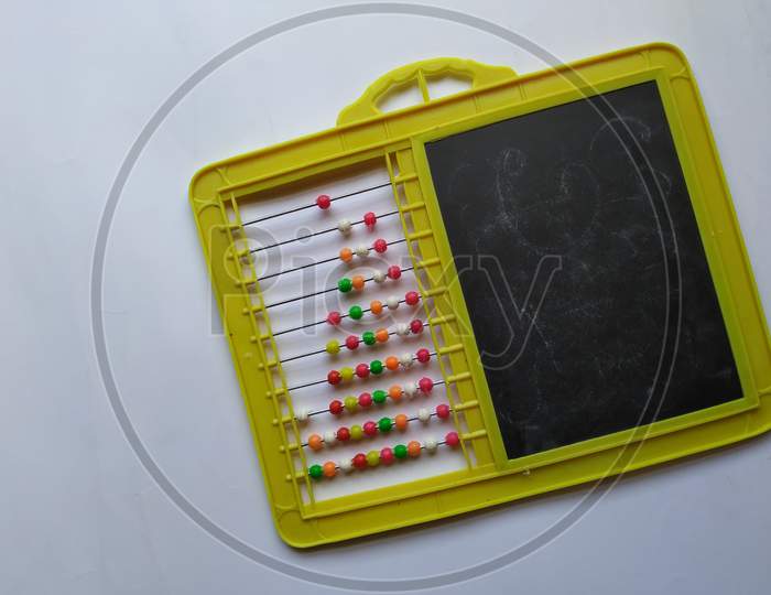 Plastic Colorful Beads for Abacus , Black Board Slate with Chalk Piece isolated on white background