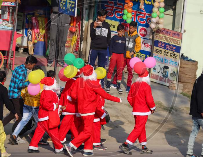 group of Santa Claus moving in the street