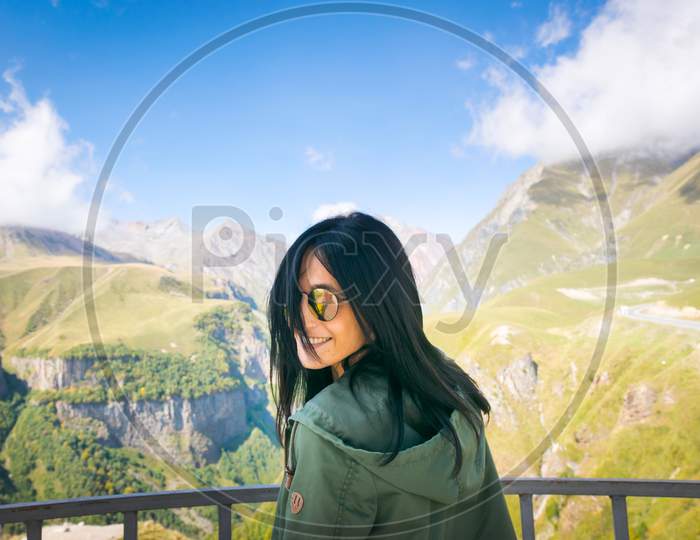 Close Up Of Attractive Caucasian Woman Turning To Camera With Happy Smilling Face And Kazbegi Mountain View Background