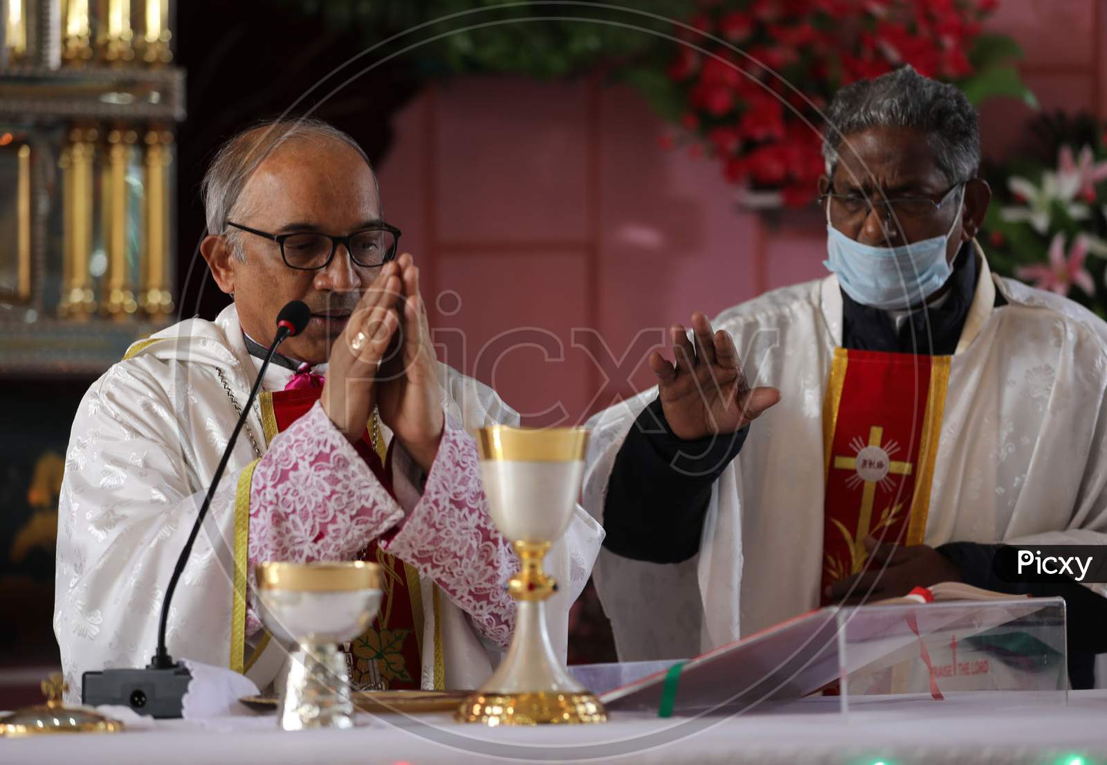 Christian priests lead a Christmas Day Mass at a church in Jammu,  25 December,2020.