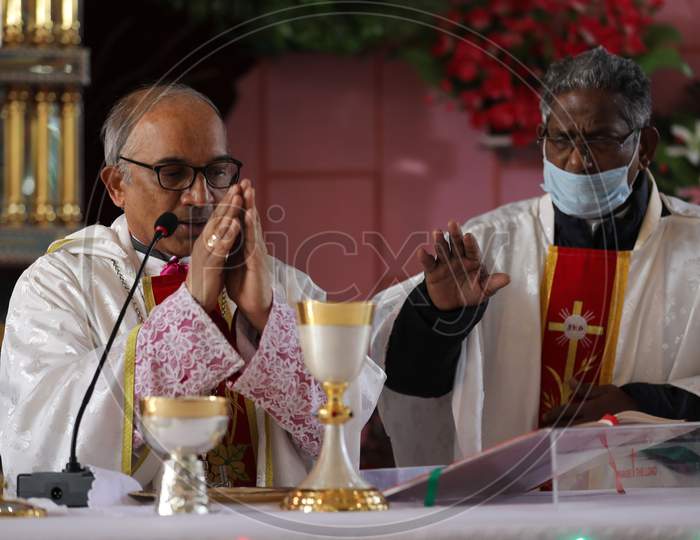 Christian priests lead a Christmas Day Mass at a church in Jammu,  25 December,2020.