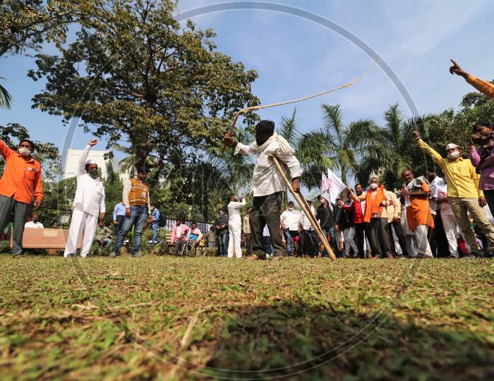 A man demonstrates his skills during a protest of farmers and members of various agricultural organisations against new farm laws passed by India's parliament, in Mumbai, India, December, 2020.