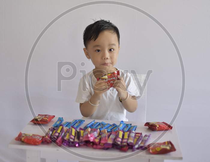 cute baby boy eating chocolate
