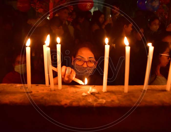 Devotees light candle at a church on the occasion of Christmas in Nagaon district, in the northeastern state of Assam, India, December 25,2020