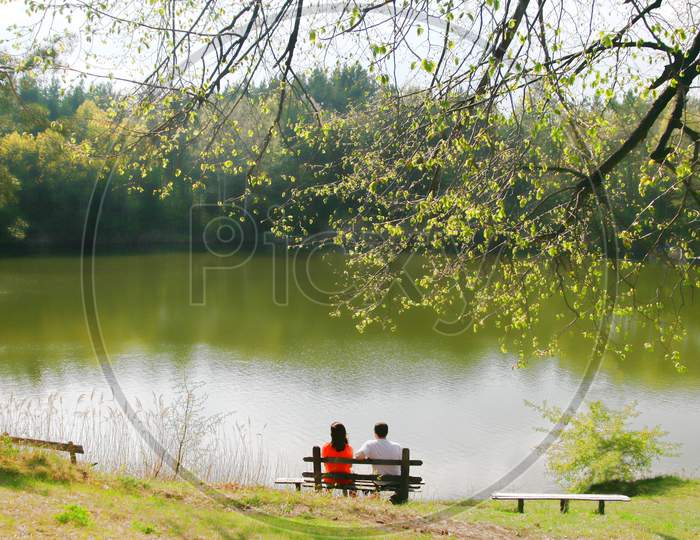 Couple On Bench Near The Lake