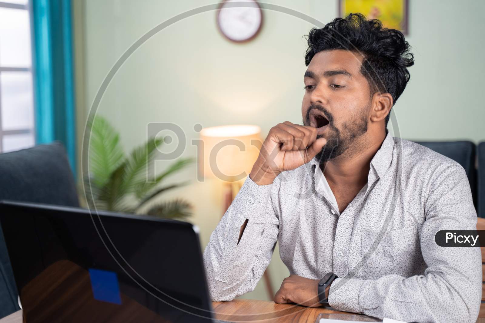 Young Man Got Tired And Yawning While Working On Laptop At Home - Concept Sleepless Work, Fatigue And Exhausted It Professional Job During Work From Home.