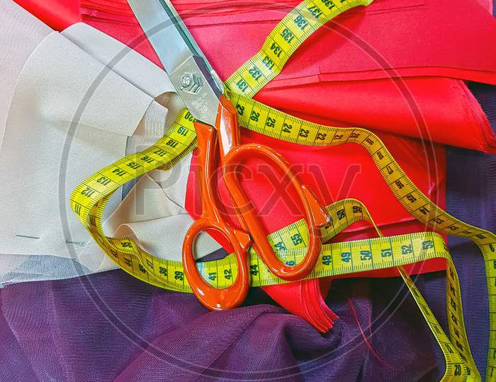 Tape Measure And Scissor Over Textile Pattern