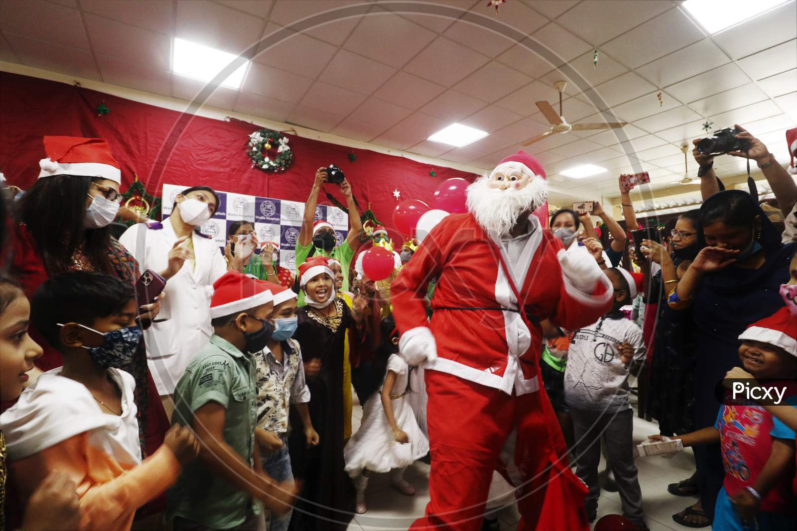 A man dressed as Santa Claus dances with patients during Christmas celebration, at Wadia Hospital For Children in Mumbai, India on December, 2020.