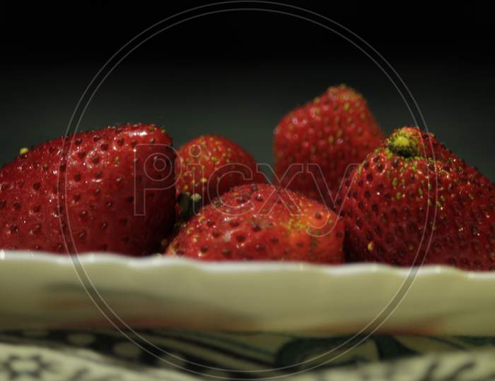 Red Fresh Organic Juicy Strawberries On A White Plate.