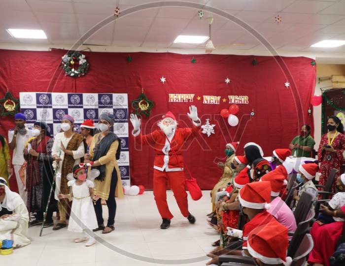 A man dressed as Santa Claus entertains patients during Christmas celebration, at Wadia Hospital For Children in Mumbai, India on December, 2020.