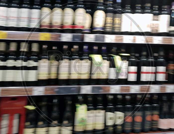 Blurred Wine Bottles On Shelf