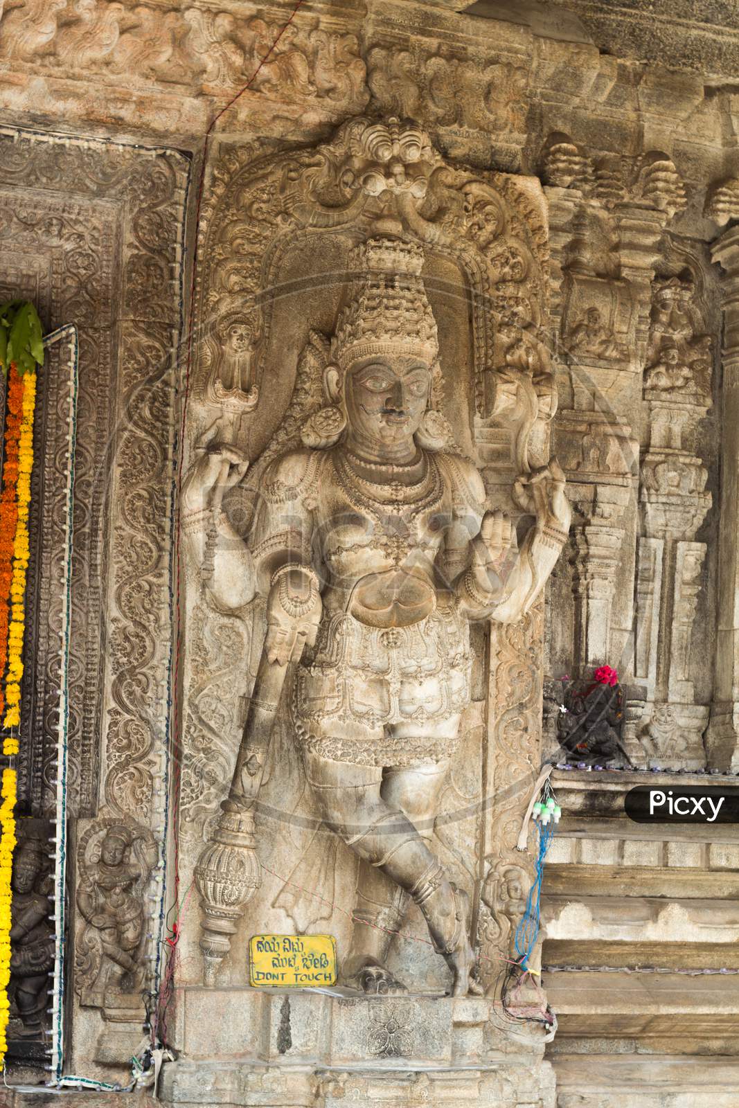 A Beautiful sculpture of an Hindu deity carved in fine detail  by dexterous hands during Vijayanagar rule at a Shiva temple in the holy town of Talakadu near Mysuru,India.
