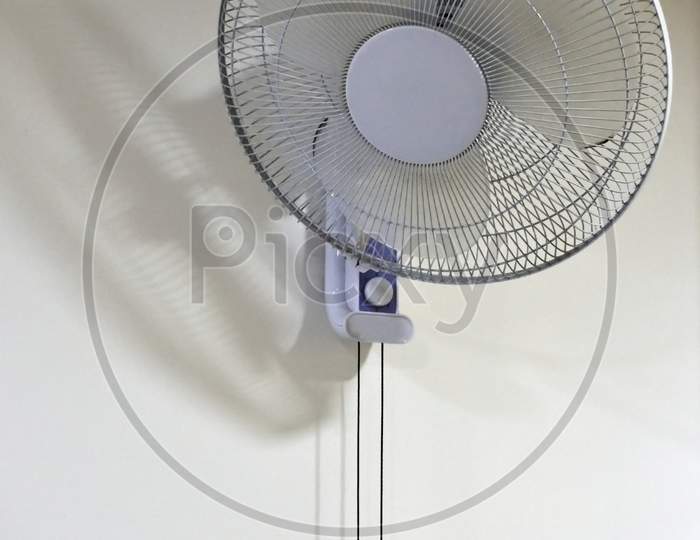 A White Color Wall Fan Fasten On The Wall