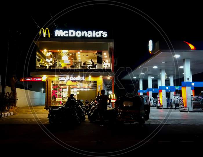 A Pleasing Dusk view of the famous McDonald's fast food Drive in restaurant in the Heart of Mysuru city in India.