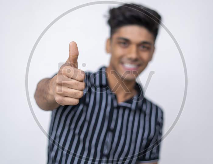 Close Up Of A Handsome Cute Asian Boy Hand Showing Thumbs Up Into The Camera.