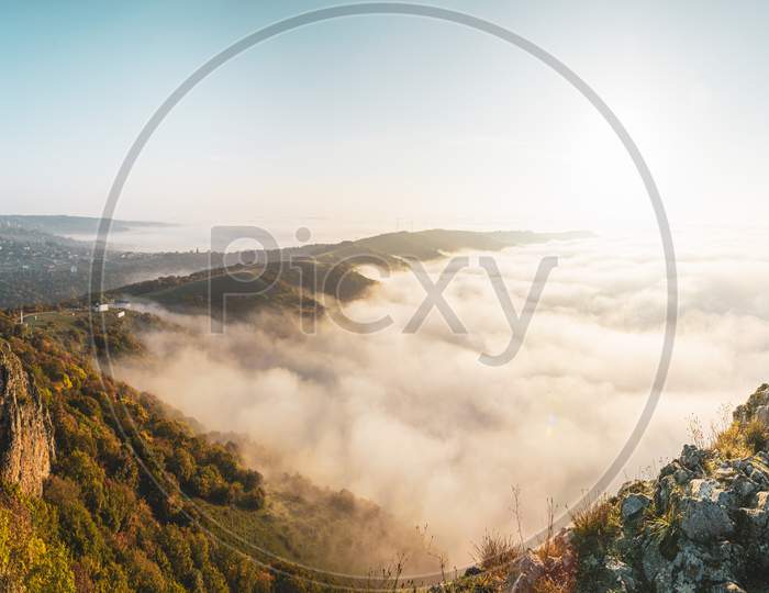 Aerial Wide View Of A Girl Taking A Photo Of Dramatic Landscape Over The Clouds In Georgia.