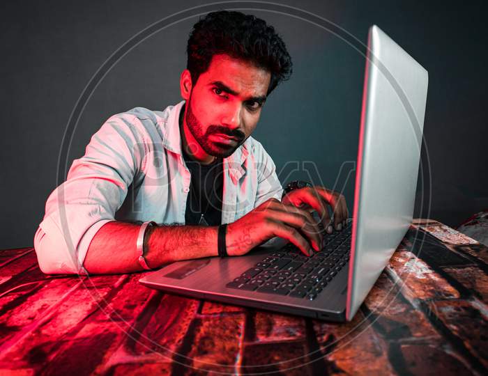 Hacker and Security Expert Working Seriously at Laptop
