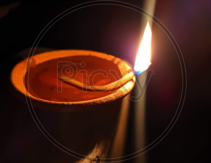 Glowing clay lamp and candle Happy diwali festive season indian festival of dipawali