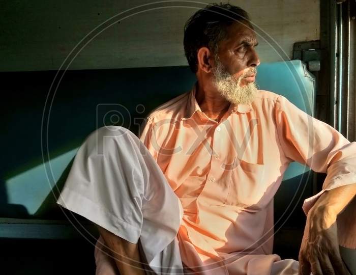 Portrait of a Muslim man sitting inside a train