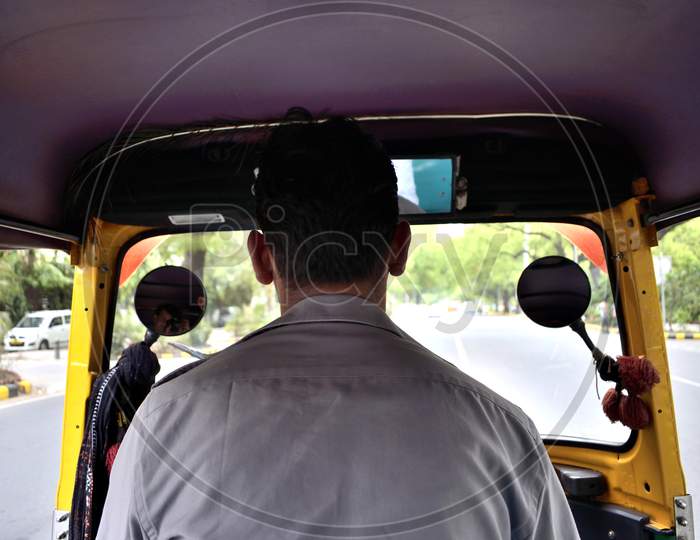 A Auto Rickshaw Driver Driving His Rickshaw On Delhi Roads