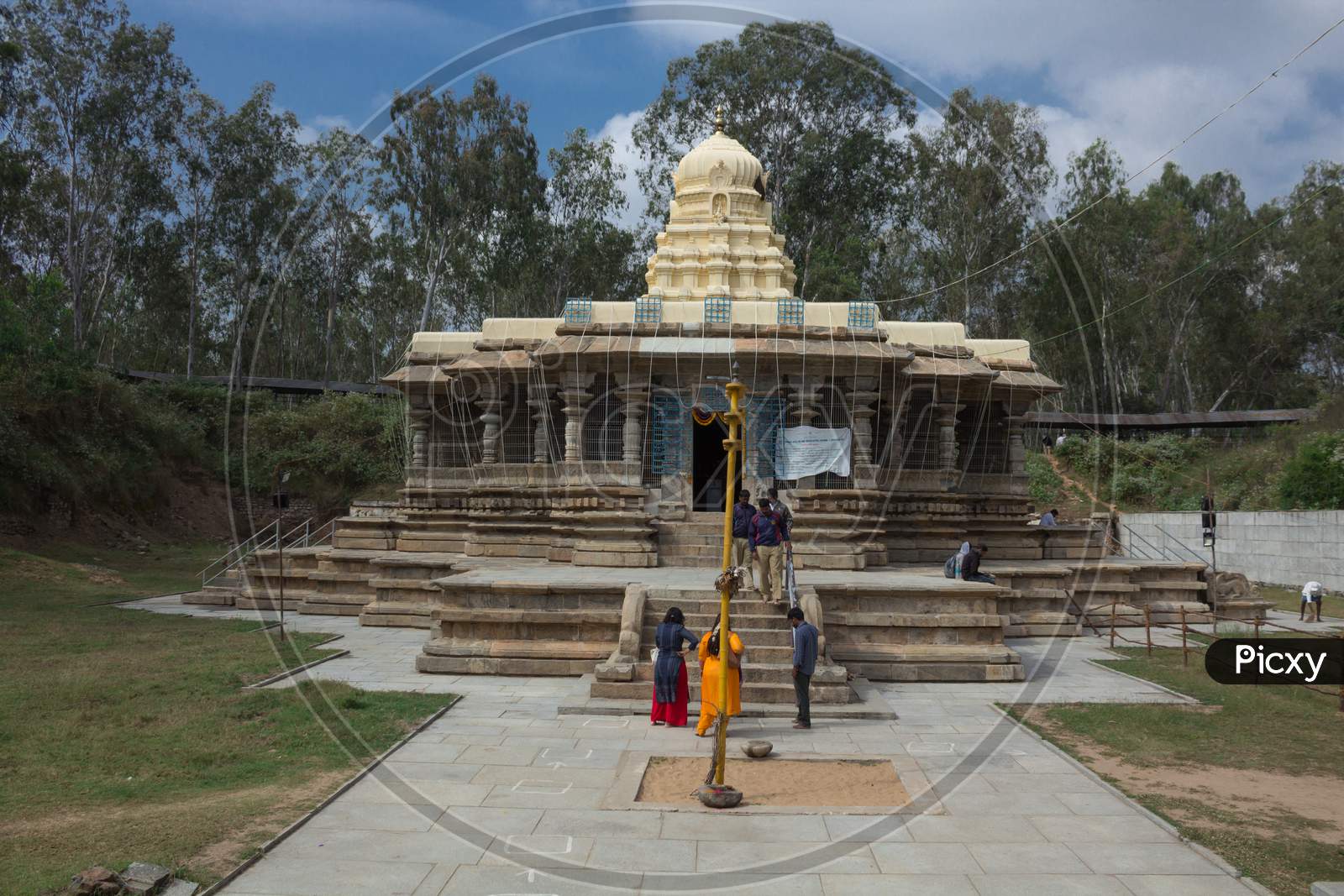 A Beautiful front view of the ancient Hindu Stone temple dedicated to lord Shiva with the pilgrims in Talakadu town which re opened after the Covid 19 lock down near Mysuru,India.