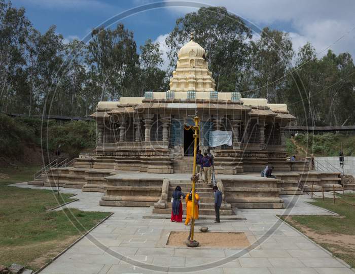 A Beautiful front view of the ancient Hindu Stone temple dedicated to lord Shiva with the pilgrims in Talakadu town which re opened after the Covid 19 lock down near Mysuru,India.