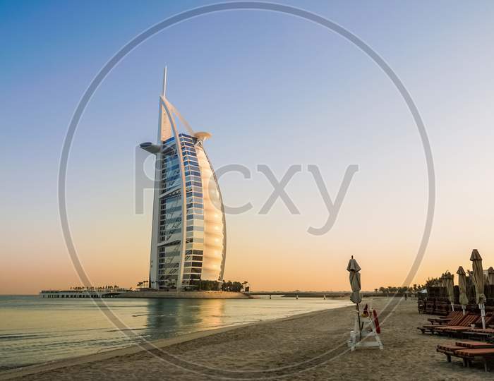 A Symbol Of Prosperity And Luxury, The Building Of The Burj Al Arab. Shore Jumeirah The Arabian Gulf In The Early Morning.