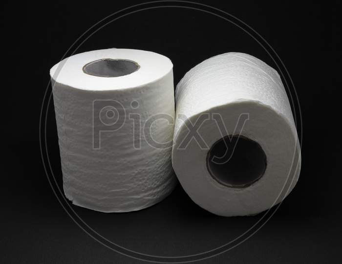 Toilet Paper Rolls Isolated on a Black Background