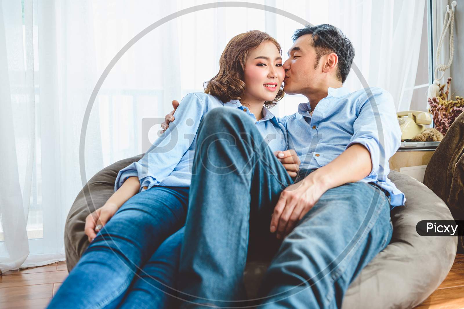 Image of Asian Couple Having Kissing Romance On Sofa In Living Room  Domestic House In Valentines Day. Lifestyle And Happiness Family  Concept.-ZU017398-Picxy