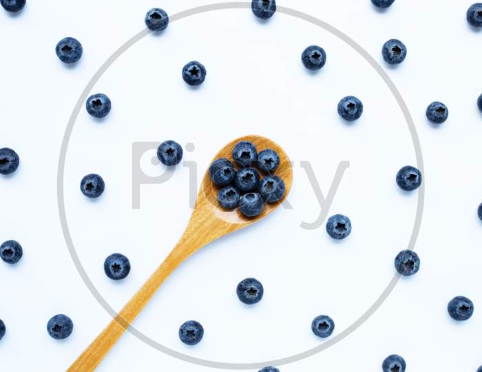 Blueberries With Wooden Spoon Isolated On White. Top View
