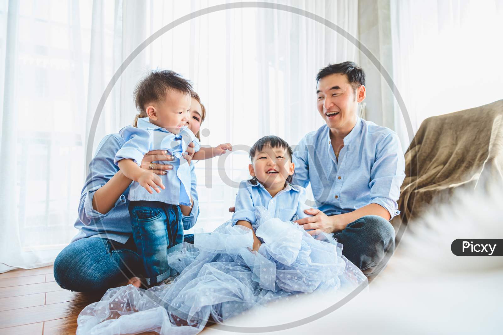 Happy Asian Family Smile And Laugh Together In Bedroom At Home. Two Parents And Children. People Lifestyle In State Quarantine After Travel On Covid-19 Or Coronavirus Epidemic Concept. Bed Foreground