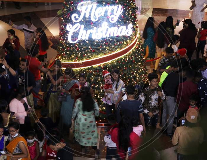 People take pictures with the christmas decoration, as they celebrate Christmas, inside a mall,  in Mumbai, India, December, 2020.