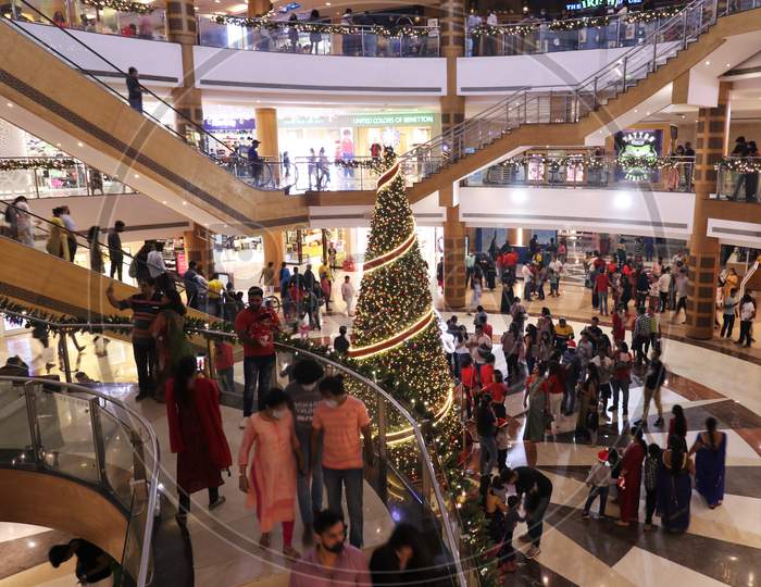 People come together, as they celebrate Christmas, inside a mall,  in Mumbai, India, December, 2020.
