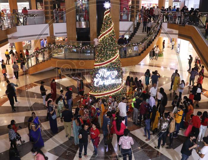 People come together, as they celebrate Christmas, inside a mall,  in Mumbai, India, December, 2020.