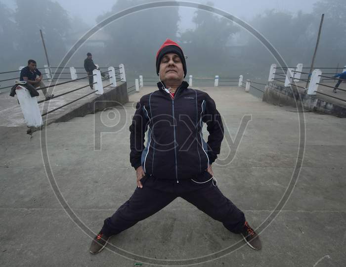 People exercise on a foggy morning  in  Assam on Dec 28,2020
