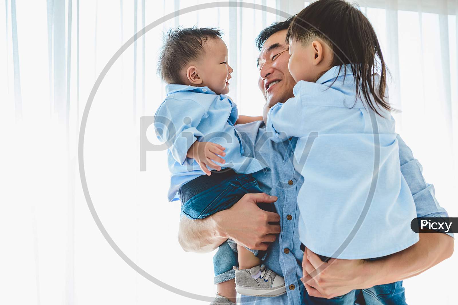 Happy Father Carrying Two Children In Bedroom At Home. Asian Family Living And Having Facial Expression Togetherness. Leisure Time. People Lifestyle Health. Quarantine Covid-19 Coranavirus Theme