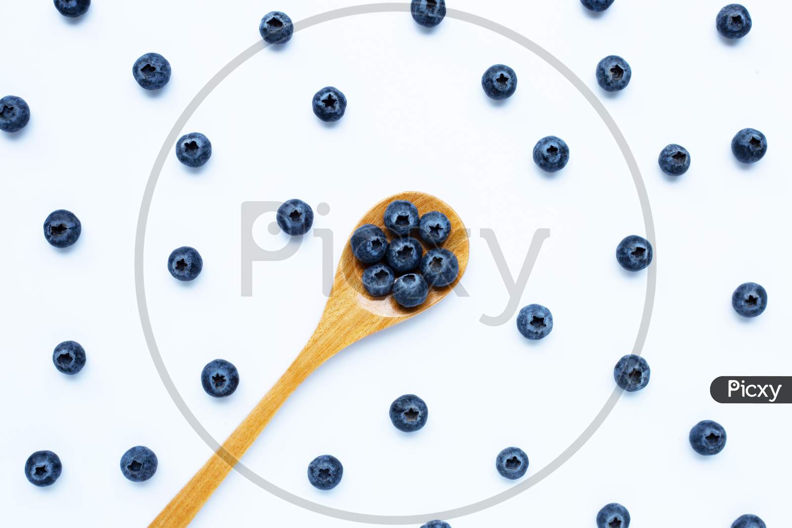Blueberries With Wooden Spoon Isolated On White. Top View