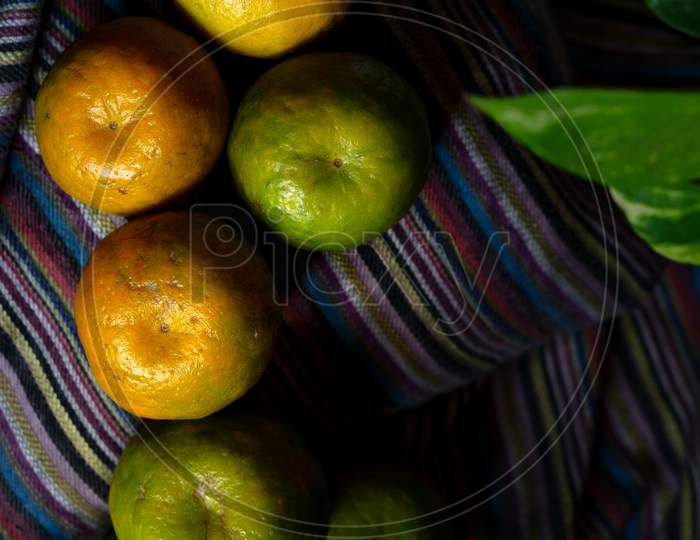 Heap Of Orange Fruit On A Dark Background