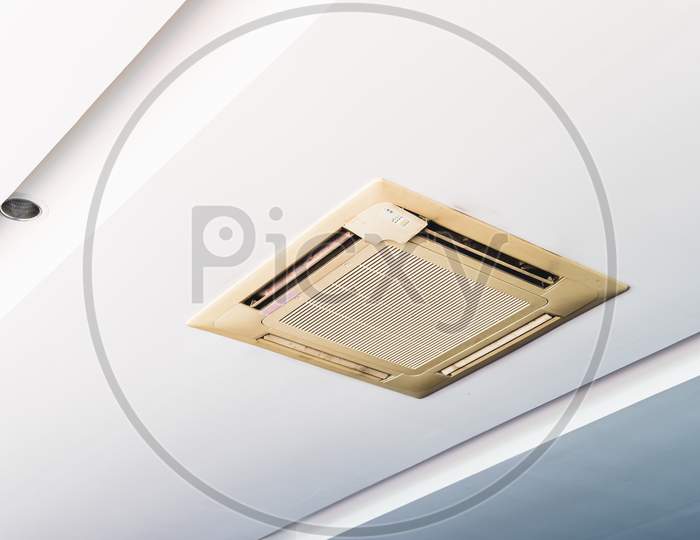 Old Cassette Type Air Conditioner On Ceiling Indoor. Electronics And Purifier Concept.