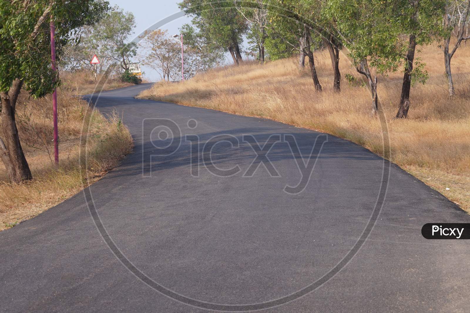 A Rural Road Through The Top Of A Hill