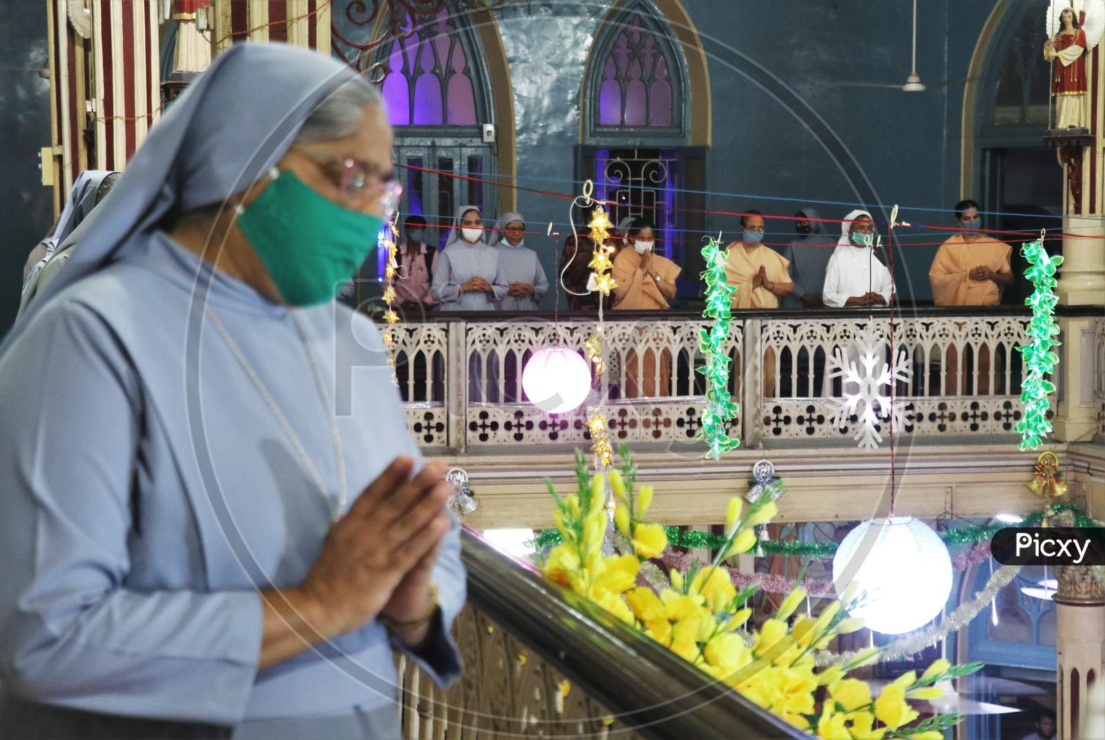 Nuns pray during mass inside a church as members of India's Christian community celebrate Christmas eve in Mumbai, India, December 24, 2020.
