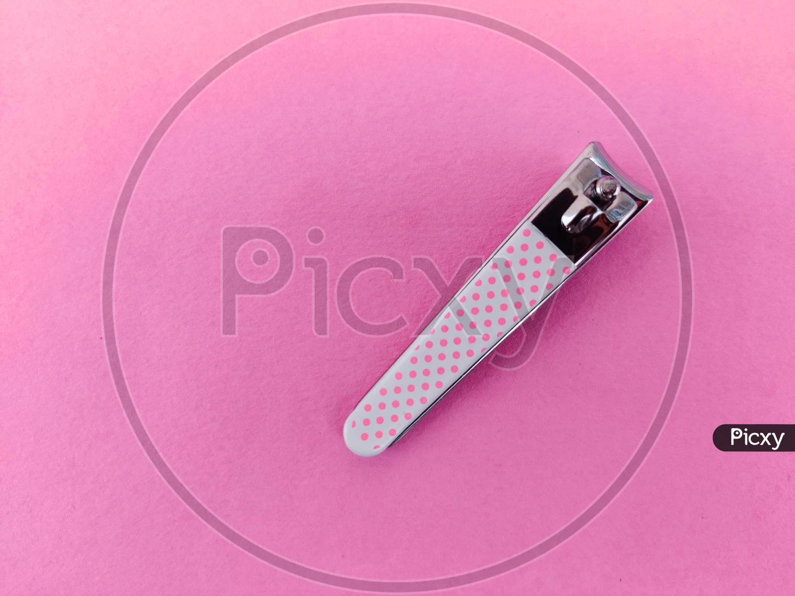 Pink Color Nail Clipper Or Nail Cutter Isolated On Pink Background