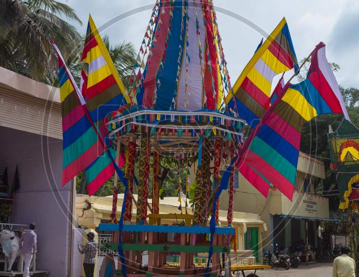 A dramatic picture of a Colorful Chariot Car used to carry the Hindu Shiva deity in the temple town of Talakadu village near Mysuru in India.
