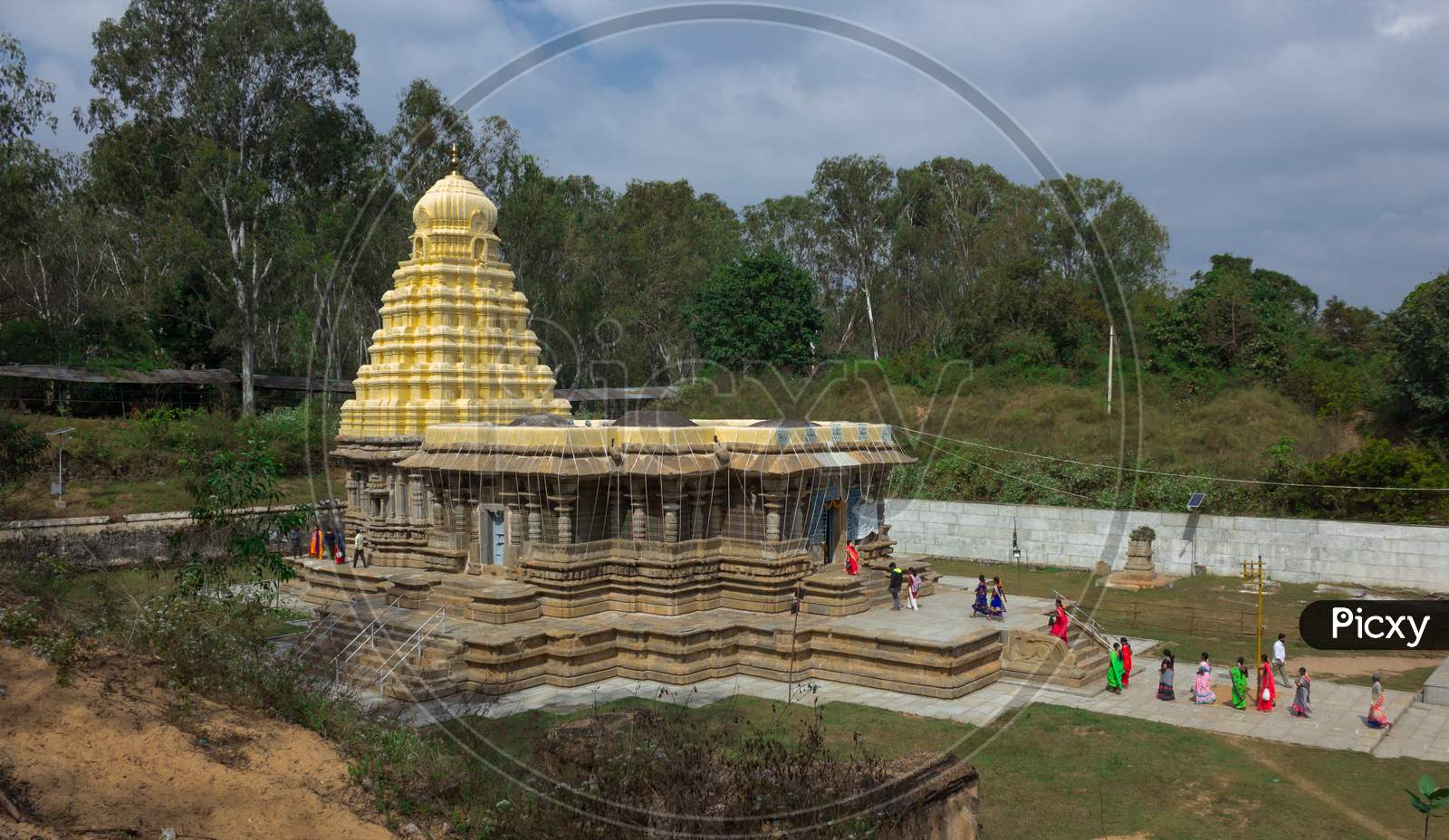 A Beautiful side view of the ancient hindu Stone temple dedicated to lord Shiva with the pilgrims in Talakadu town which re opened after the Covid 19 lock down near Mysuru,India.