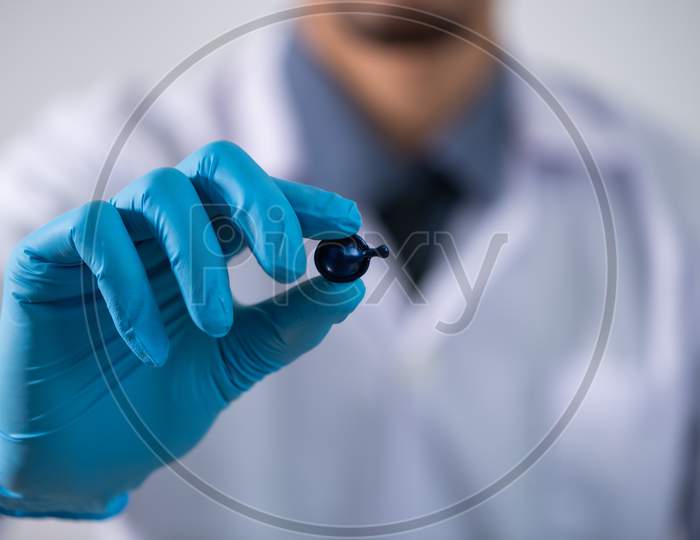 Scientists studying a virus ,looking through microscope.Scientists in protective suits in a science laboratory study a virus. covid19 blood test