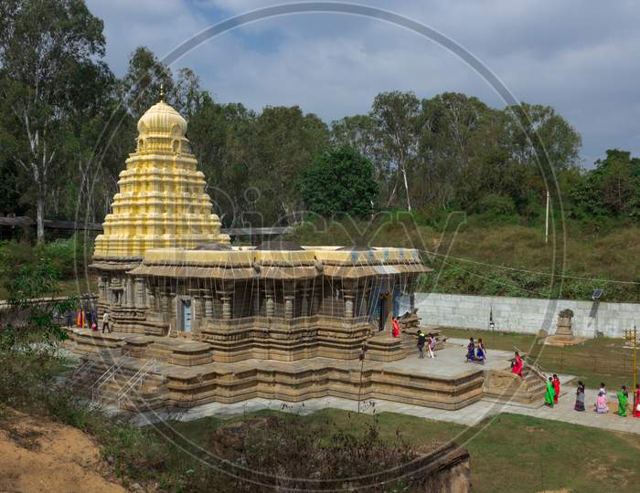 A Beautiful side view of the ancient hindu Stone temple dedicated to lord Shiva with the pilgrims in Talakadu town which re opened after the Covid 19 lock down near Mysuru,India.