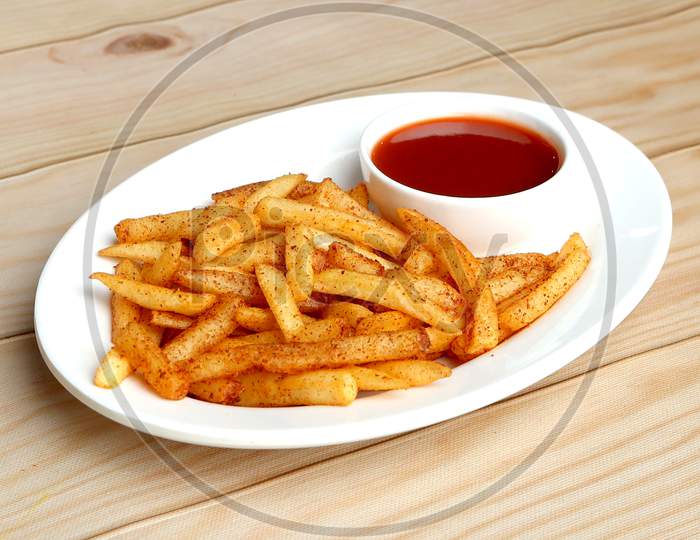 Tasty Spicy Peri Peri French Fries With Tomato Ketchup Served In A Bowl Over A Rustic Wooden Background, Selective Focus